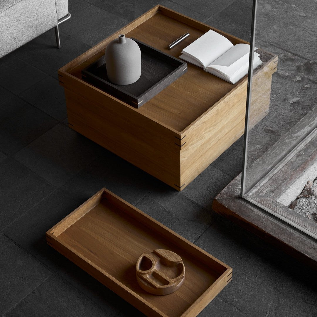 Modern wooden coffee table in natural tones with a sleek, minimalist design and subtle grain patterns.