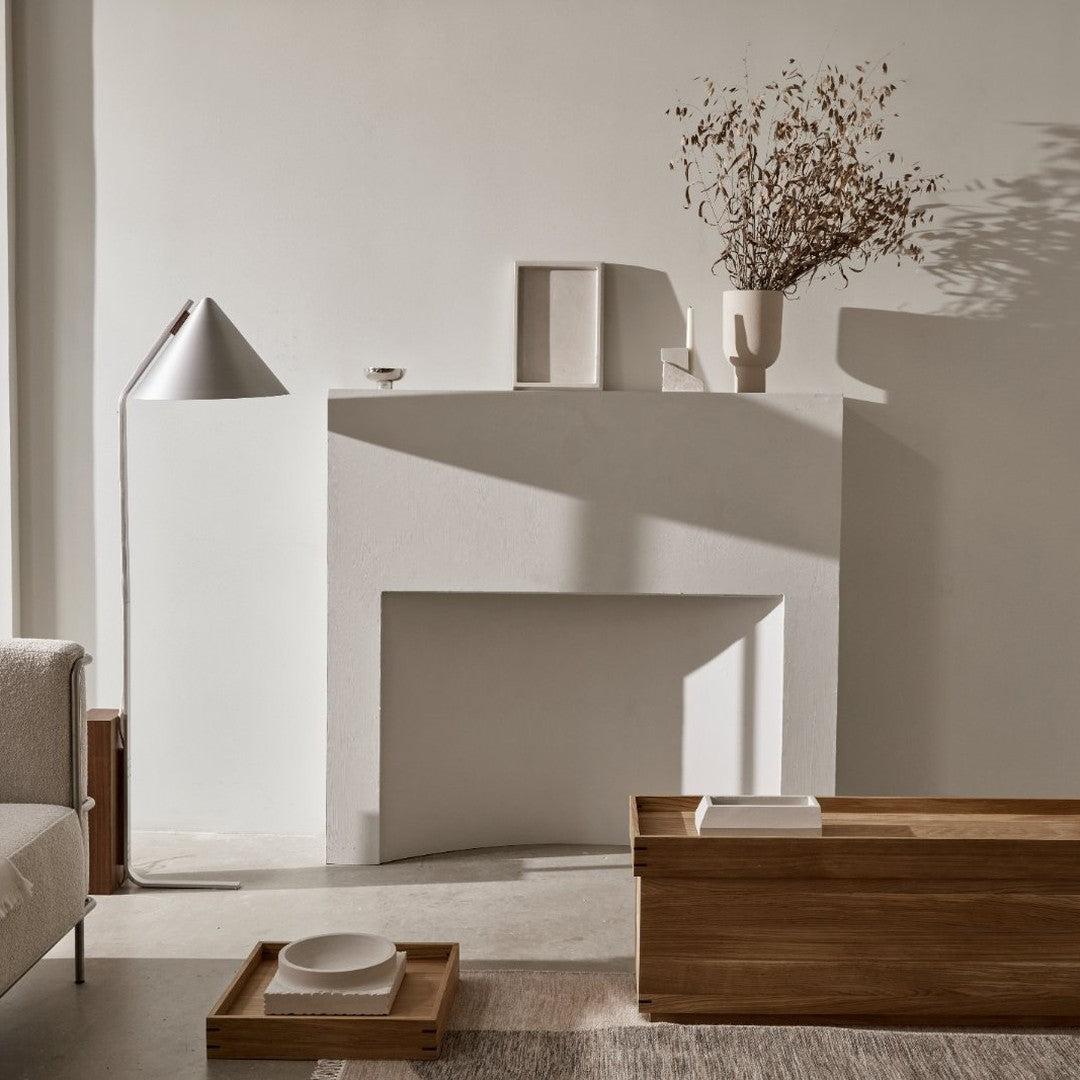 Neutral tones and soft shadows with warm wood accents and simple, elegant decor create a serene, modern ambiance.