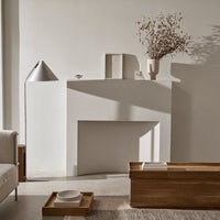 Neutral tones and soft shadows with warm wood accents and simple, elegant decor create a serene, modern ambiance.