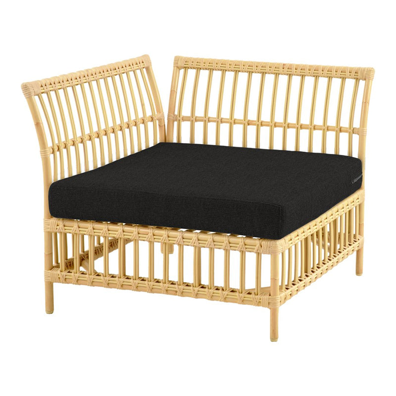 Natural rattan lounge chair in light tan with a solid black cushion, featuring a minimalist vertical slat pattern.