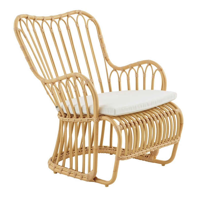 Natural bamboo chair with a creamy white cushion, featuring a modern, open-weave design and smooth, curved lines.