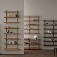 Minimalist wooden wall shelves in light oak and dark walnut, featuring sleek lines and modern design.