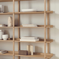 Natural wood shelves with a light finish, styled with neutral-colored ceramics and minimalist decor elements.