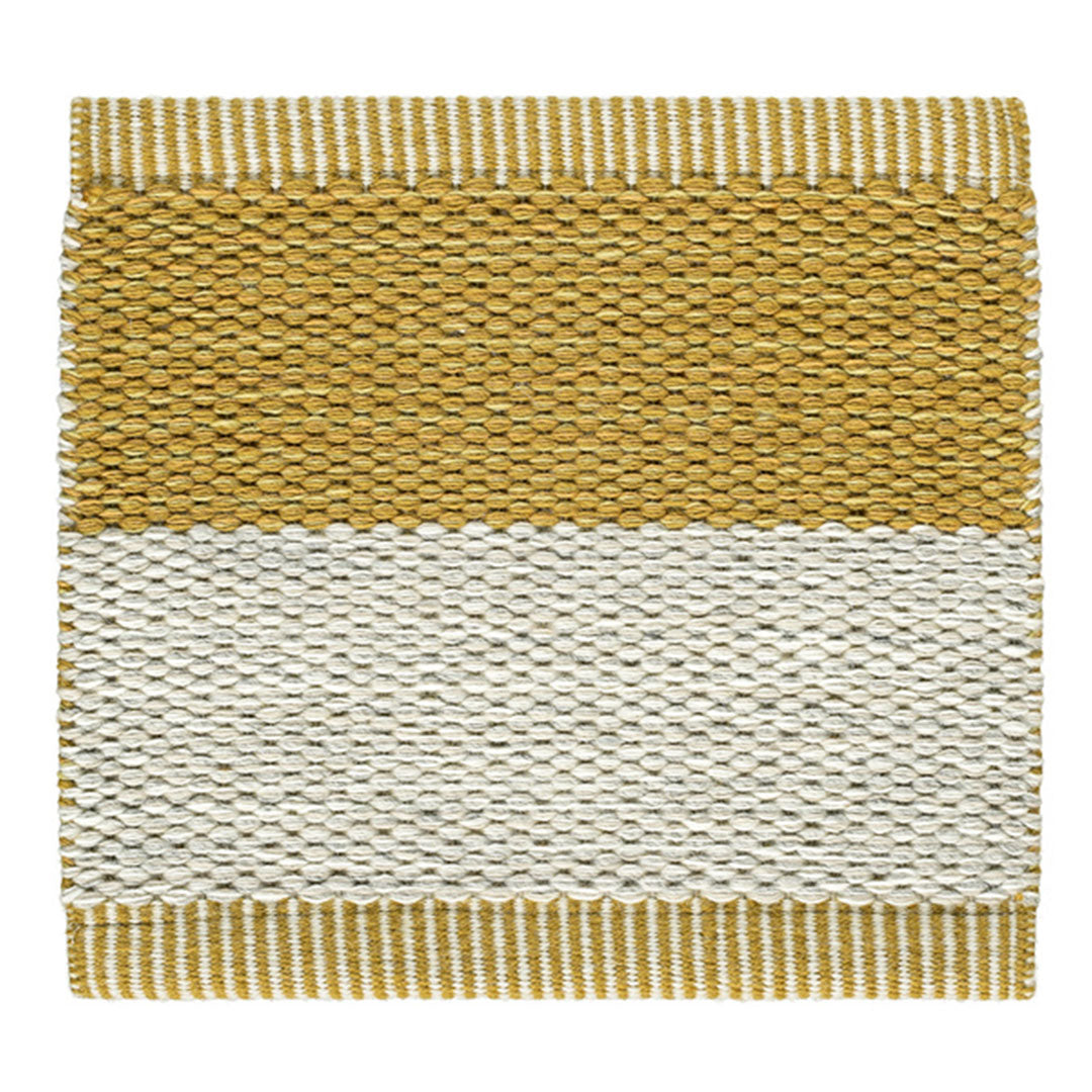 "Textured yellow and white woven rug with geometric pattern, perfect for adding a modern touch to any space."