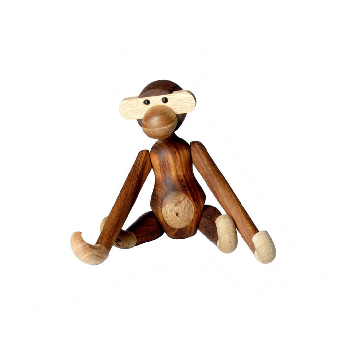 Wooden monkey figurine in rich brown and light beige tones with smooth, natural wood grain patterns.