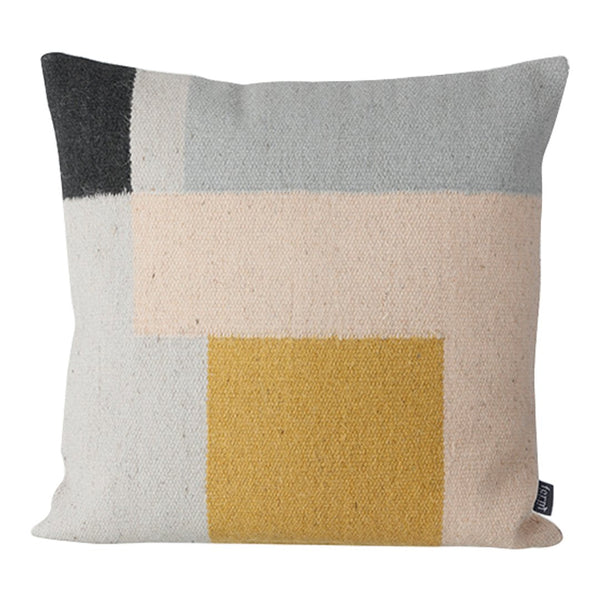 Colorful geometric cushion featuring soft pastels, gray, black, and a bold yellow square pattern. Perfect for modern decor.