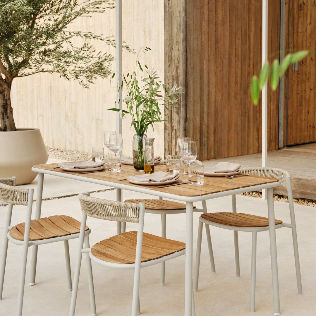 "Minimalist outdoor dining set featuring natural wood tones and sleek white frames, perfect for modern spaces."