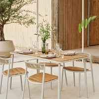 "Minimalist outdoor dining set featuring natural wood tones and sleek white frames, perfect for modern spaces."
