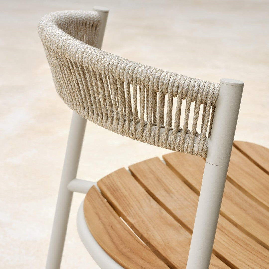 Beige woven back chair with white frame and round wooden seat, showcasing natural textures and modern design.