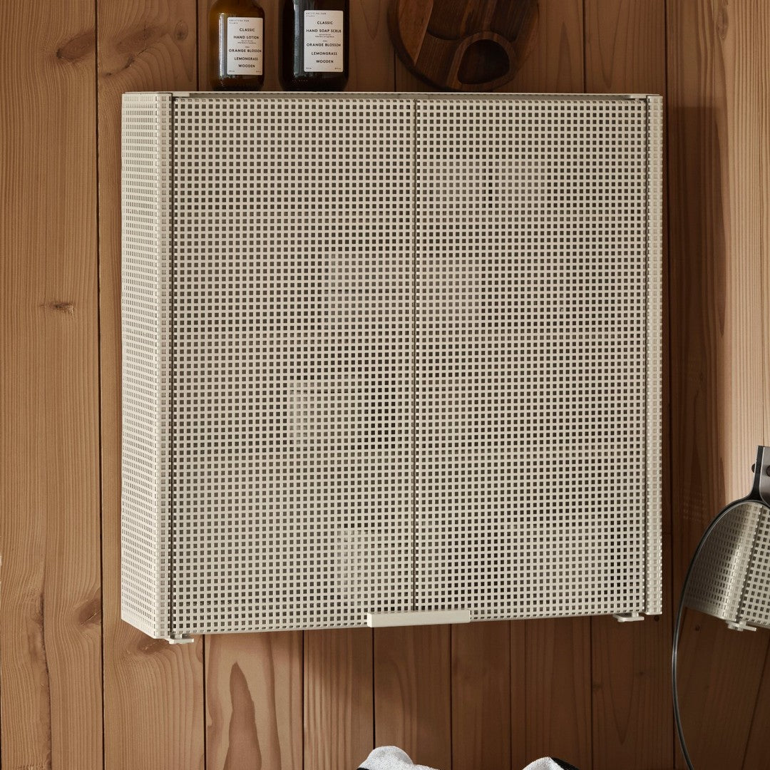 Beige perforated wall cabinet with a grid pattern against a wooden backdrop. Modern and minimalist design.