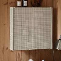 Beige perforated wall cabinet with a grid pattern against a wooden backdrop. Modern and minimalist design.