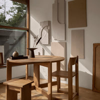 Natural wood tones with subtle textures and soft shadows, featuring minimalist design accents against a light backdrop.