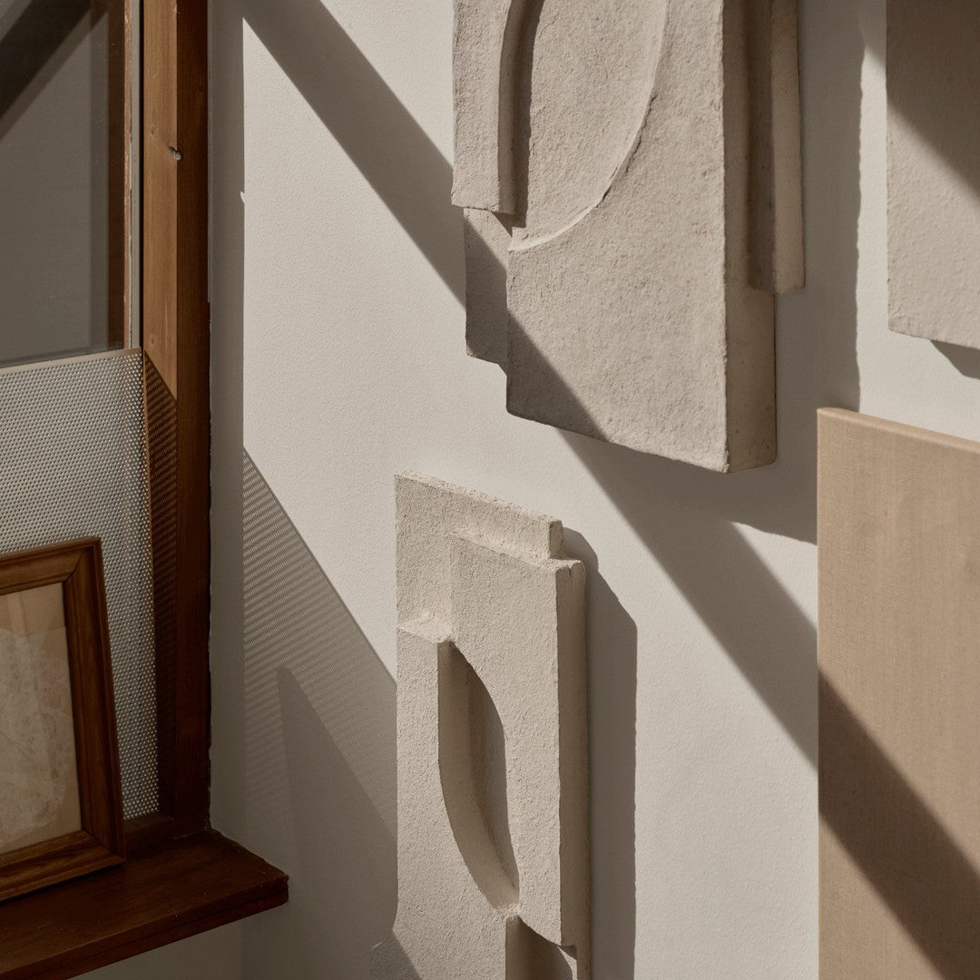 Textured neutral wall art in soft beige and creamy tones, featuring geometric shapes and a modern aesthetic.