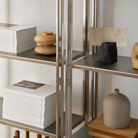Neutral tones with earthy textures; natural wood, smooth ceramics, and sleek metals create a modern aesthetic.