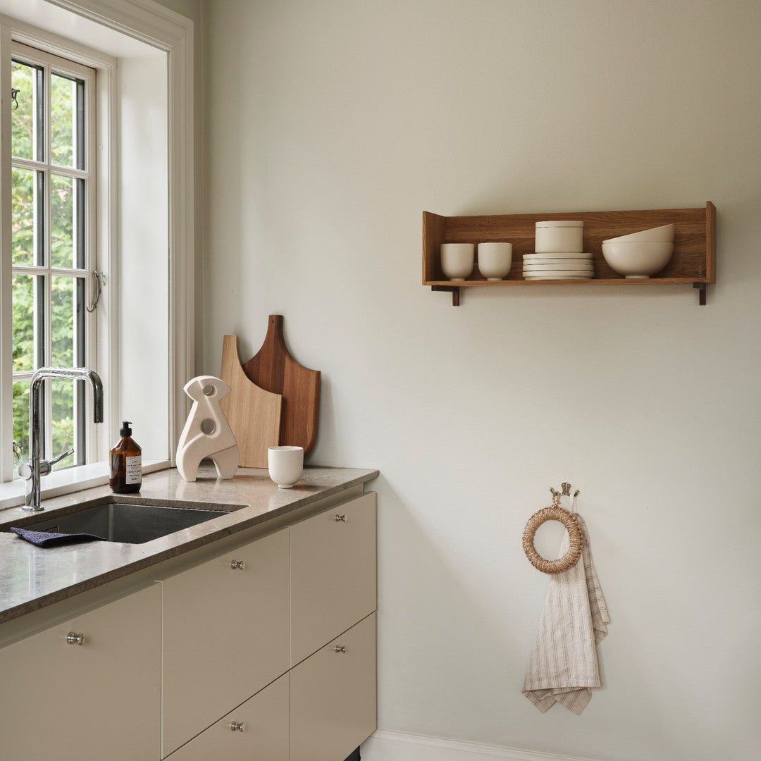 Neutral-toned kitchen accessories featuring soft beige and warm wood textures, with simple, modern lines.