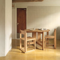Natural wooden dining table and chairs in warm tones, featuring clean lines and minimalist design.