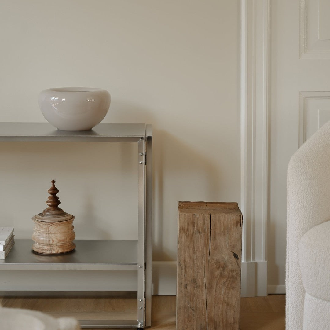 Neutral gray shelf with light wood accents, a soft beige bowl, and rustic wooden elements, creating a calming decor aesthetic.