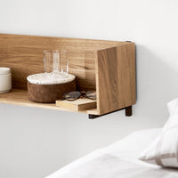 Natural wood shelf in warm oak tones, featuring smooth finishes and minimalist design with subtle textures.