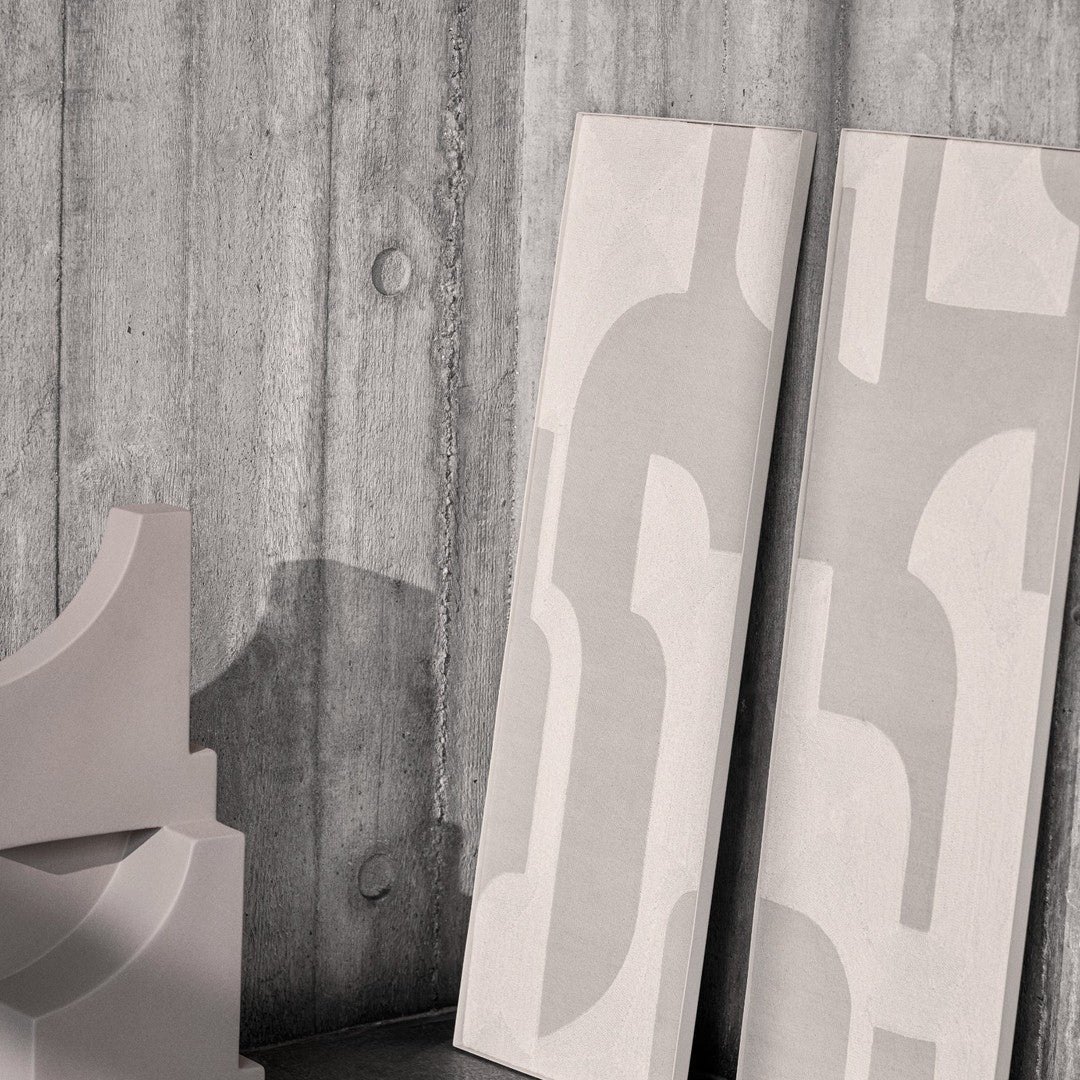 Light gray abstract patterns on smooth panels against a textured concrete backdrop. Modern and minimalist design.