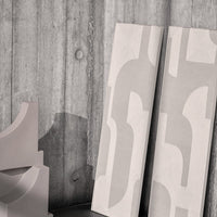 Light gray abstract patterns on smooth panels against a textured concrete backdrop. Modern and minimalist design.