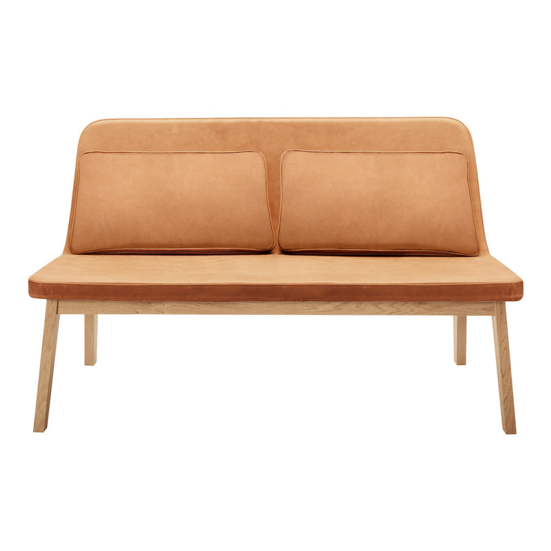 "Light brown suede loveseat with smooth texture and simple design, featuring two matching cushions."
