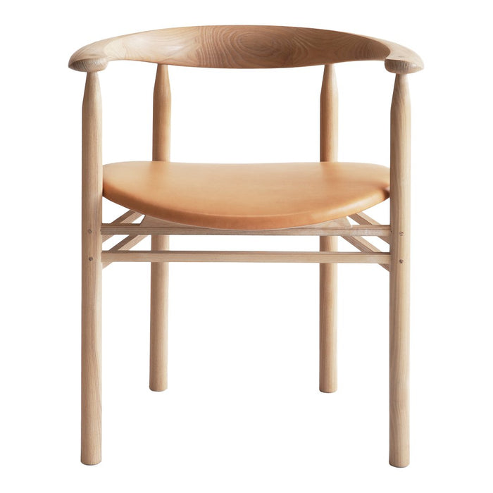 Light natural wood chair with a smooth, tan leather seat and minimalist design, featuring soft curves and clean lines.
