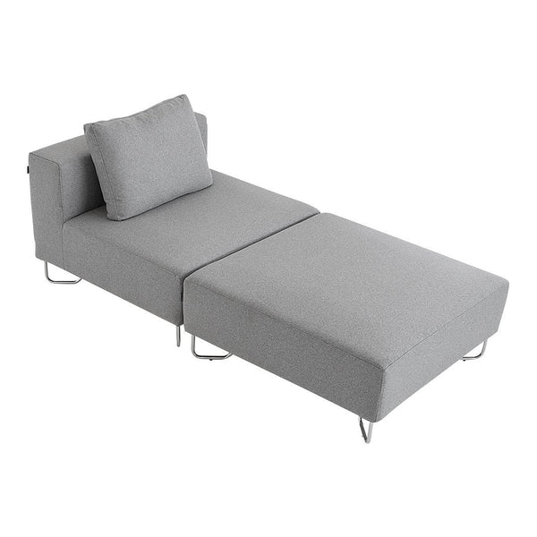 Light gray chaise lounge with a sleek, minimalist design and textured upholstery. Stylish metal legs complete the look.