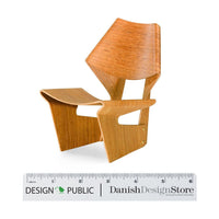 Mid-century modern chair in light wood with smooth, natural grain and sleek angles, ideal for minimalist décor.