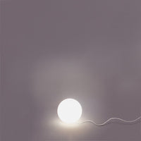 Round white lamp on a soft gray background, illuminated with a smooth, minimalistic design.