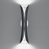 "Modern wall light in sleek black and white design, featuring graceful curves and a minimalistic pattern."