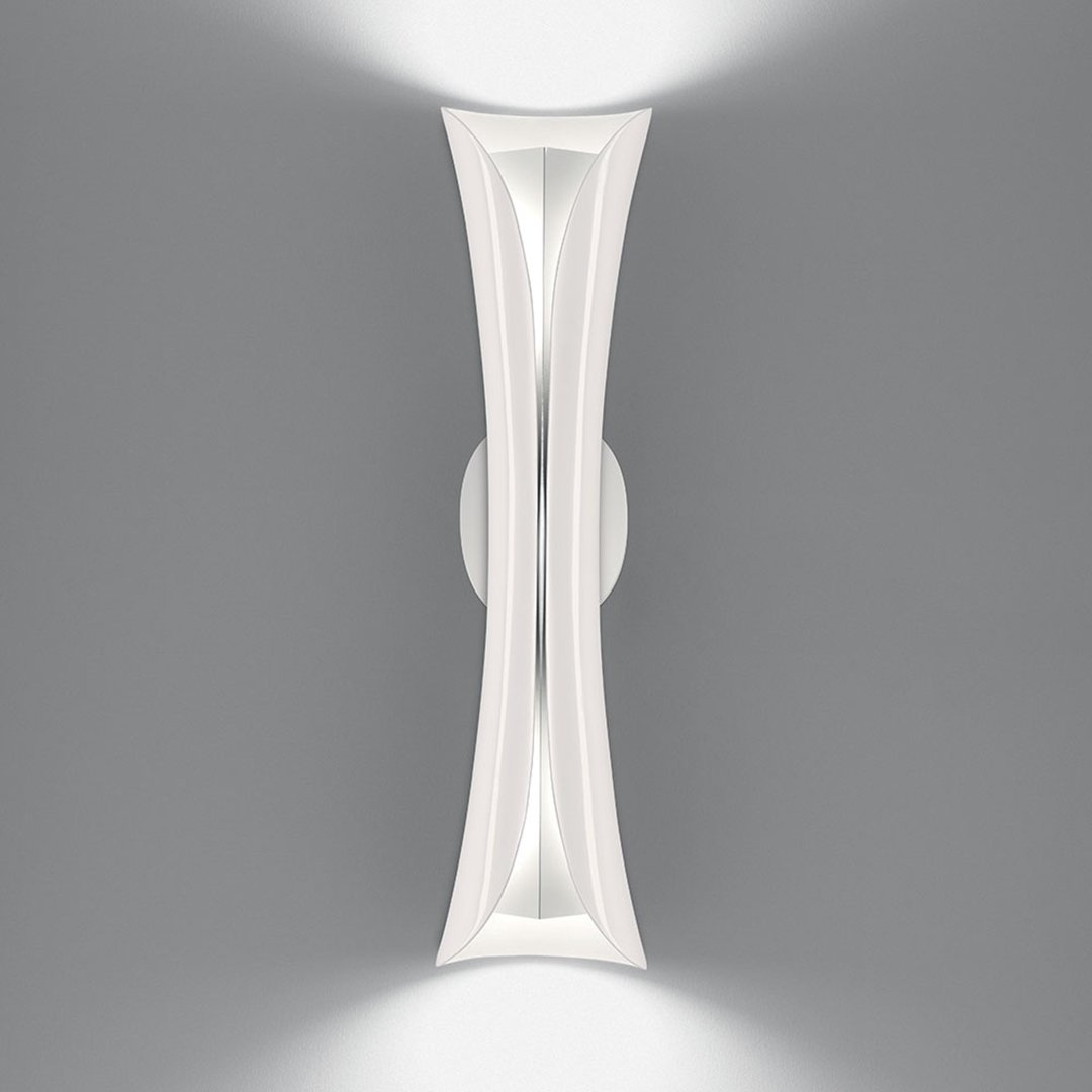 Sleek white wall light with modern curves and subtle shadow patterns against a grey background.