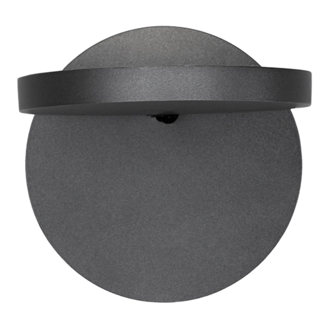 Matte black round wall sconce with a sleek, minimalistic design and smooth circular patterns.