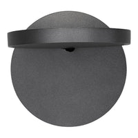 Matte black round wall sconce with a sleek, minimalistic design and smooth circular patterns.