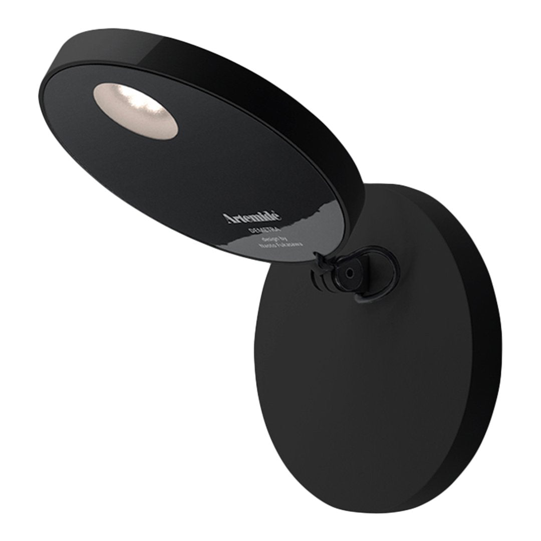 Sleek black wall lamp with a round base and modern accent light design. Minimalistic style perfect for contemporary decor.