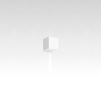 Minimalist white cube with a smooth, seamless texture, set against a soft gray gradient background.