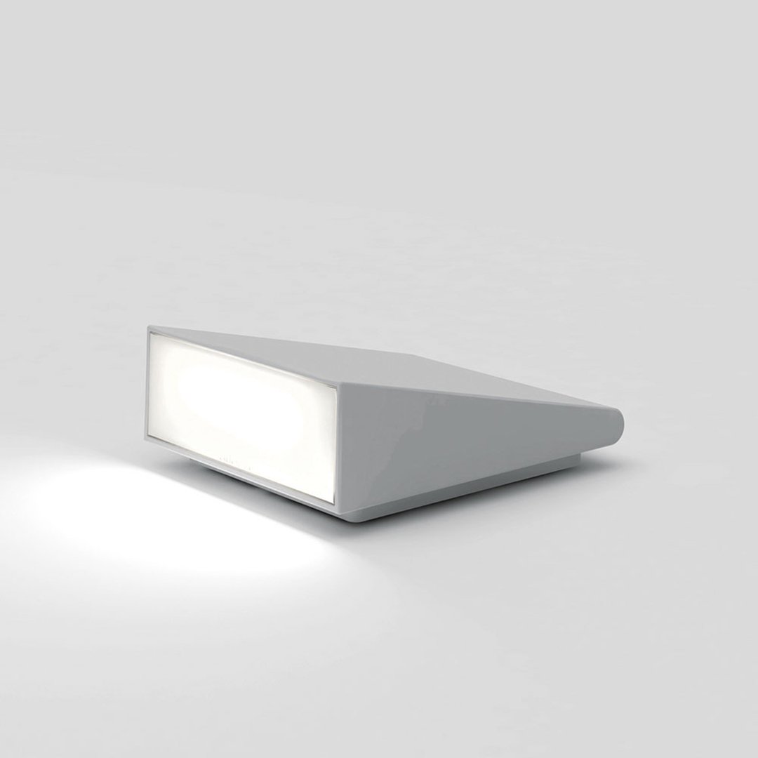Sleek white geometric lamp with a smooth finish, featuring a soft glow for modern decor.