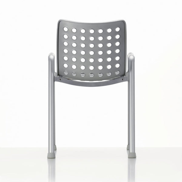 Gray chair with a perforated backrest and silver metal legs against a white background.