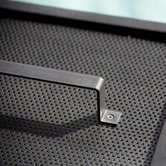 Black perforated surface with a sleek metal handle, featuring a modern and minimalist design.
