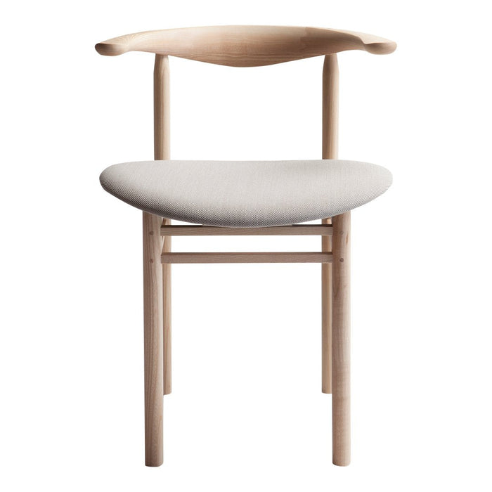 Light wood chair with a curved backrest and soft gray upholstered seat. Minimalist design, modern aesthetic.