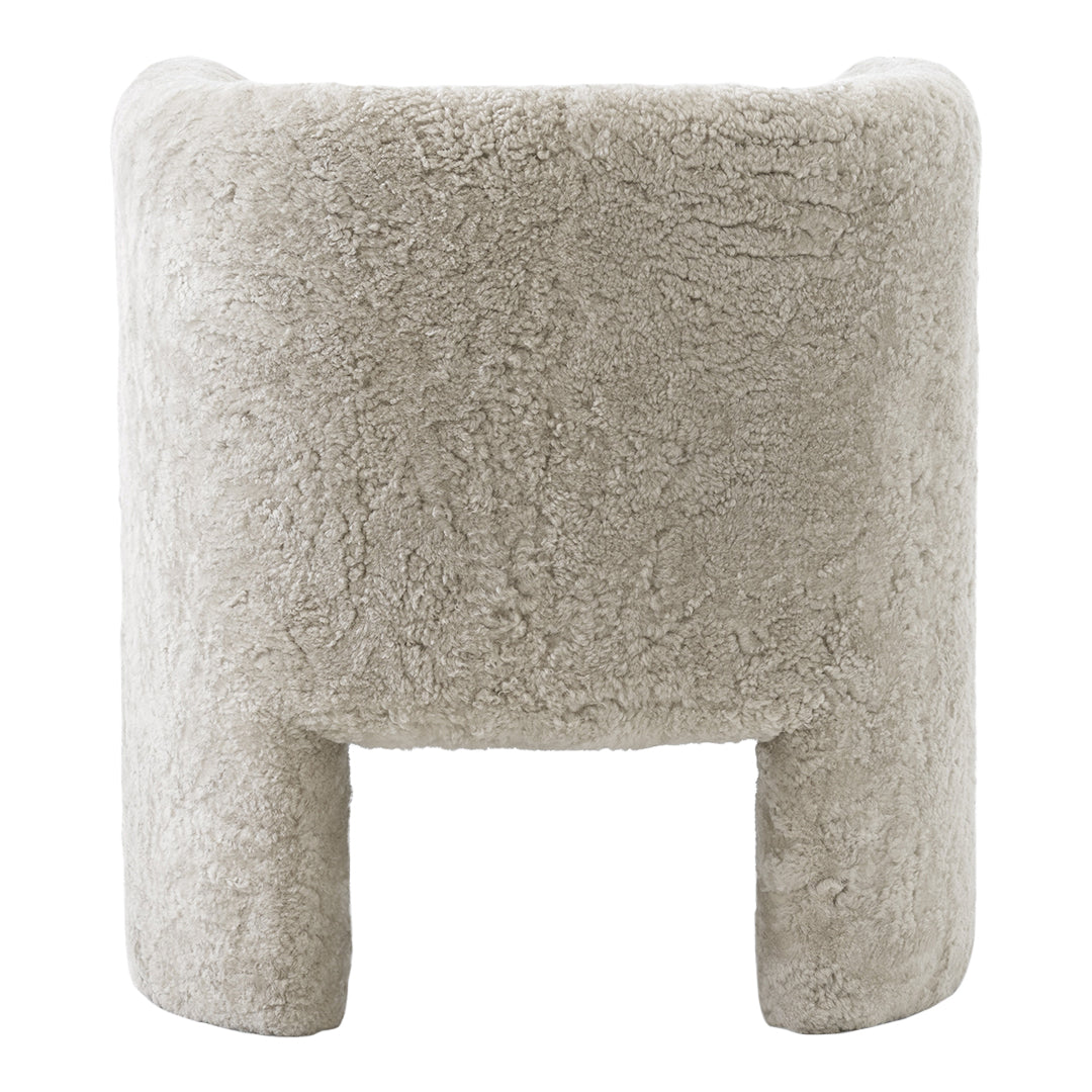 Soft beige textured chair with a cozy, fluffy appearance and minimalist design. Perfect for stylish decor.