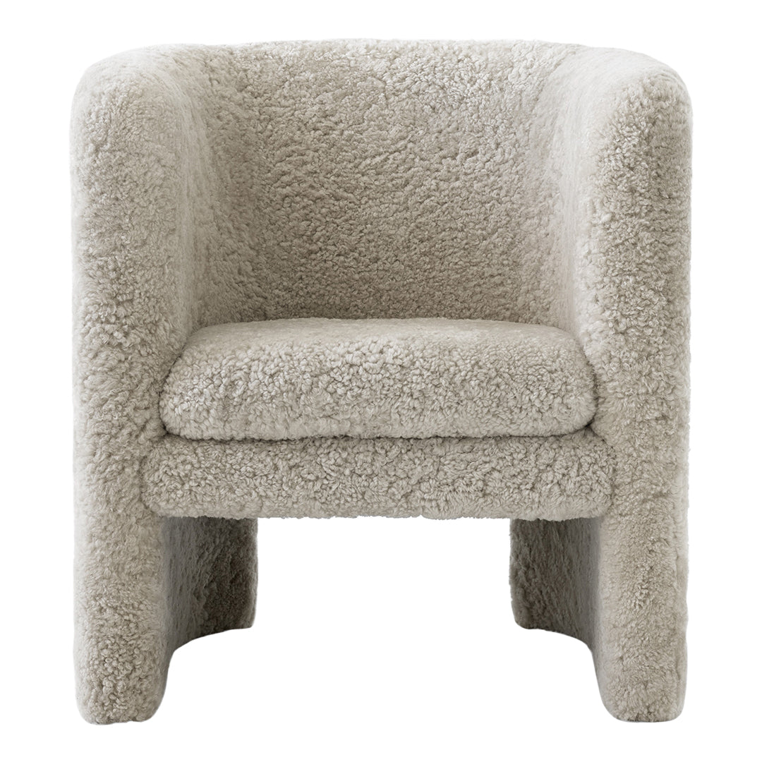 Cozy beige boucle accent chair with plush, textured fabric and a rounded design for modern interiors.
