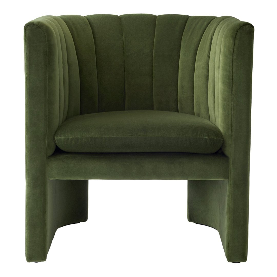 Green velvet armchair with ribbed pattern, featuring a modern, stylish design. Perfect for any contemporary space.