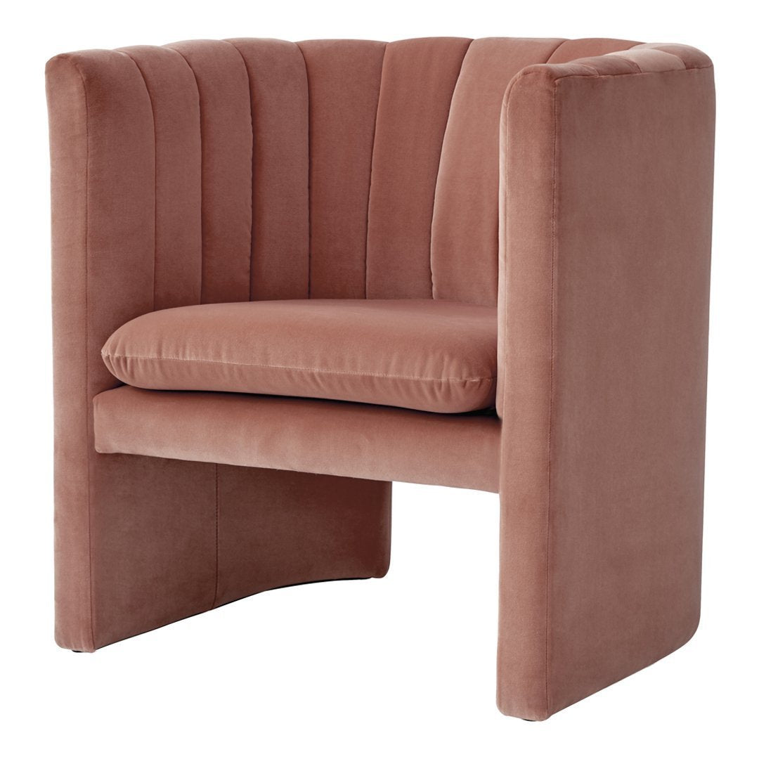 Blush pink velvet accent chair with a ribbed pattern, offering a chic and modern design.