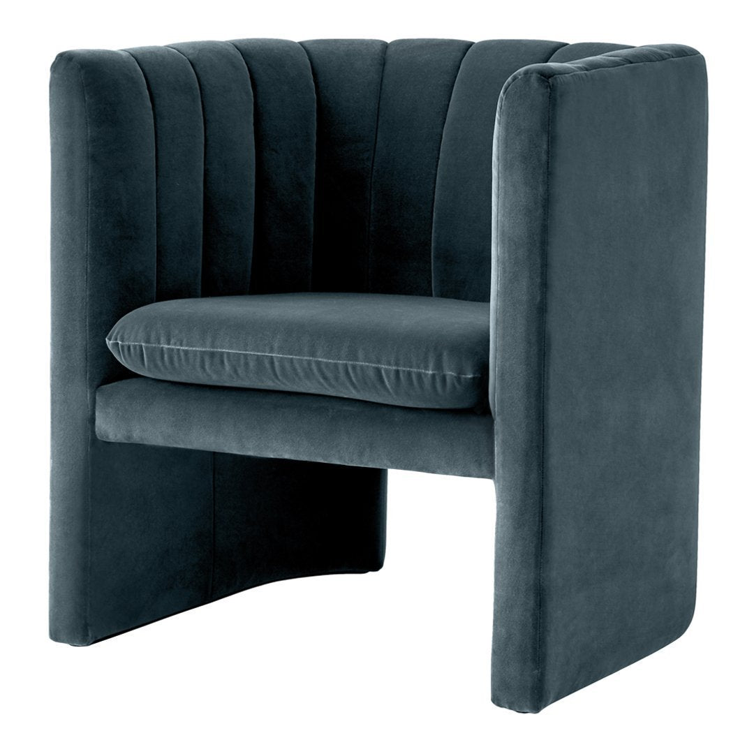 Stylish dark teal velvet chair with vertical channel tufting, adding a modern touch to any decor.