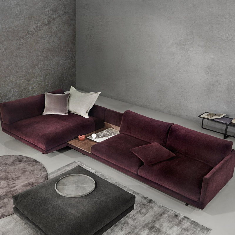 Plush burgundy sofa set with minimalist gray accents and soft textures, complemented by subtle geometric patterns.