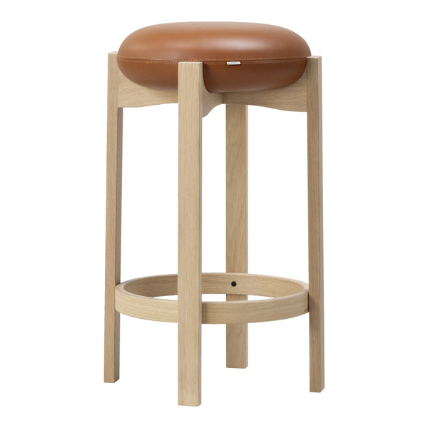 Light wooden stool with a smooth tan leather seat, minimalistic design and natural finishes. Perfect for modern decor.