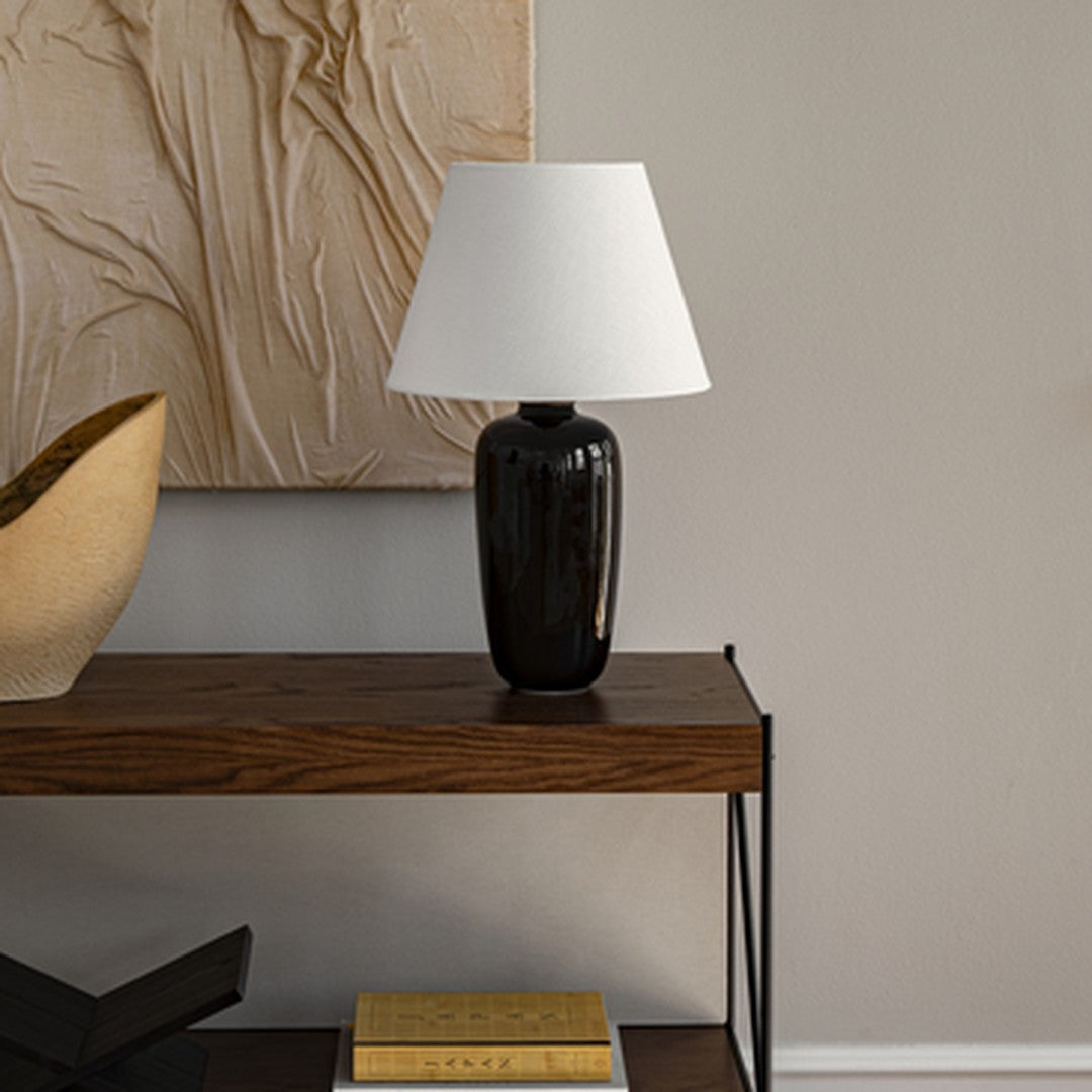 "Modern black table lamp with white shade, accentuating minimalist decor and adding elegance to any room."