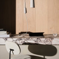 Elegant black and white marble countertop with natural wood paneling, featuring subtle veining patterns.
