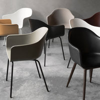 Elegant chairs in black, white, beige, brown, and olive green with sleek, modern designs and varied textures.