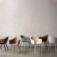 Six stylish chairs in earthy tones: brown, gray, beige, and olive green with various textures and finishes.